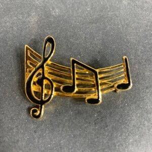 Vintage gold tone music staff and treble clef black enamel lapel pin/brooch